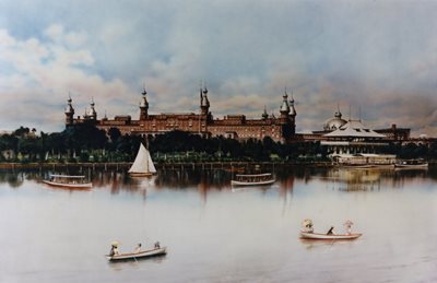 painting of Tampa Bay Hotel, river in foreground with boats, clouds in sky