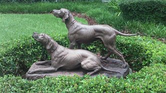 modern photo of statue of 2 hunting dogs.