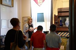 Museum docent sharing history with students