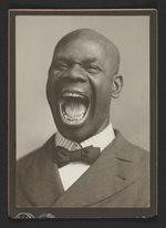 portrait of a bald, African American man, mouth wide open in a yell, wearing a suit and tie