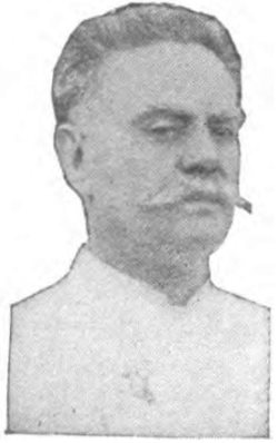 portrait of man with mustache wearing chef jacket