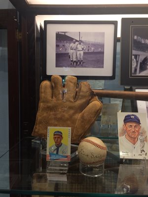 Partial display of baseball memorabilia: leather glove baseball cards photo of players signed baseball