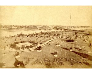 historic photo of Tampa Bay Hotel gardens, plant bed spelling "Tampa" visible in foreground, river in background