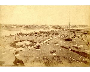 historic photo of Tampa Bay Hotel gardens, plant bed spelling "Tampa" visible in foreground, river in background