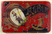 Album cover. Red leather with gold, uside down horsehoe. Picture of young boy with yellow kite inside the horseshoe, "Album" in gold over black background to right of horseshoe, rowboat with sail beneath "Album". Made in Germany on bottom left corner.