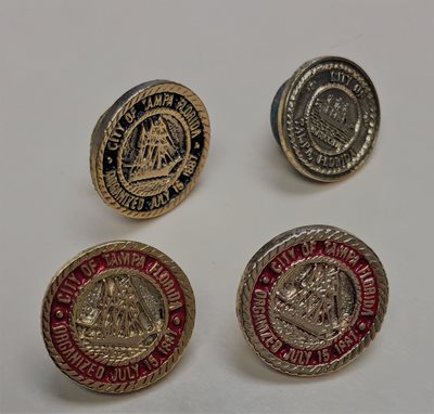 4 round lapel pins with gold trip, image of old-fashioned sailing ship in the center, "City of Tampa Florida" around the rim