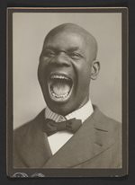 Minstrels-Image-4.jpg portrait of a bald, African American man, mouth wide open in a yell, wearing a suit and tie