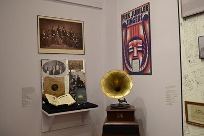 museum exhibit case including portraits and a Fisk Jubilee Singers poster.