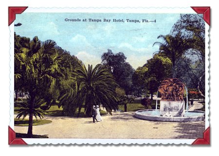 fountain surrounded by exotic plants and a strolling couple
